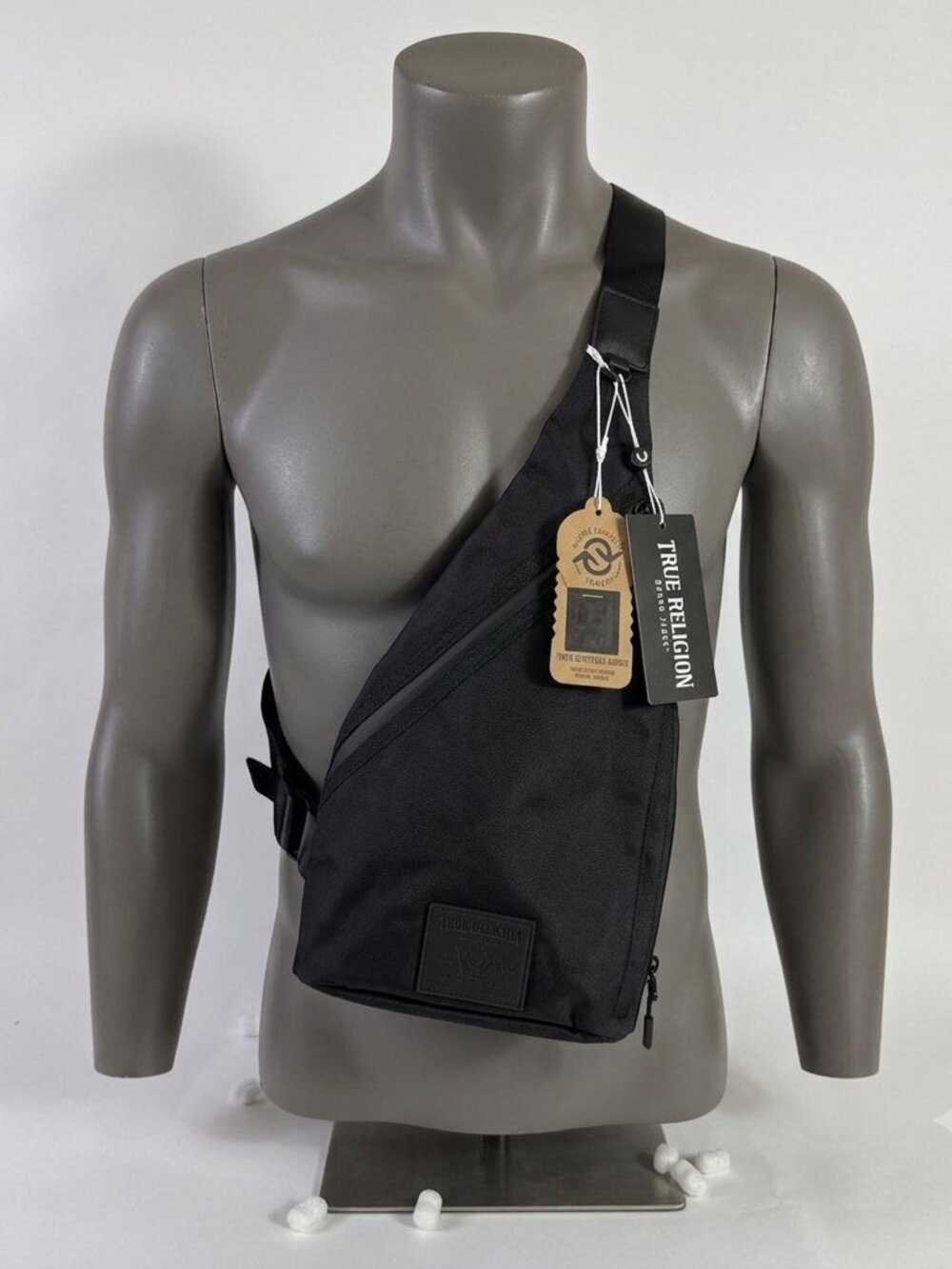 True Religion Black Sling Bag Features a Textured Black Logo Patch on the Front